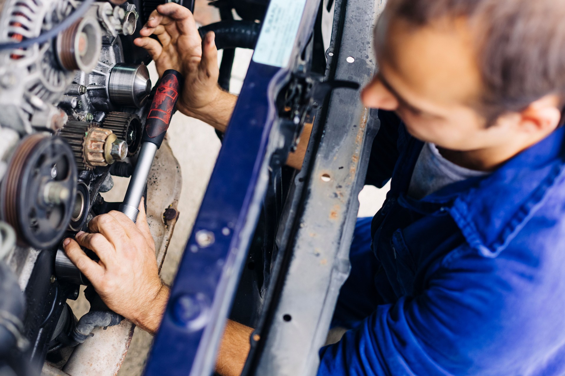 Mechanic Working On Car Engine